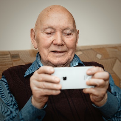 retired person looking at cell phone