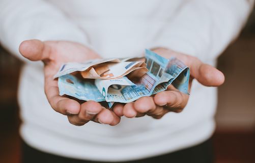 person with cash in hands